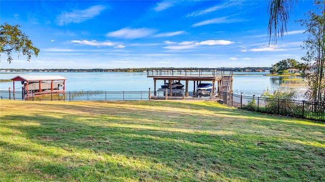 dock area featuring a water view and a yard