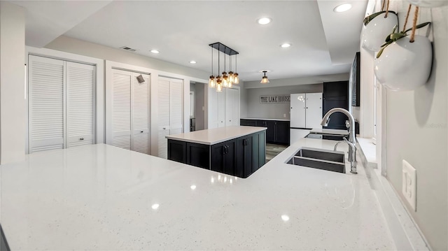 kitchen with pendant lighting, sink, and a center island