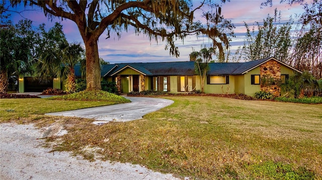 ranch-style home with a yard