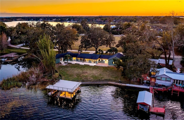 aerial view at dusk with a water view