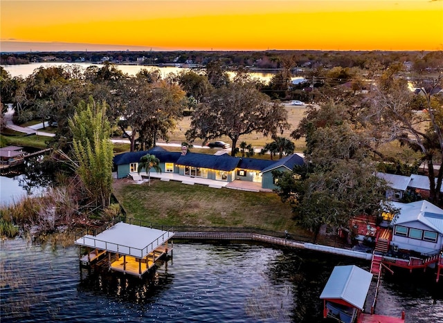 aerial view at dusk with a water view