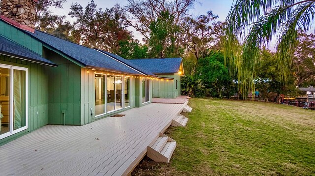 deck at dusk with a lawn