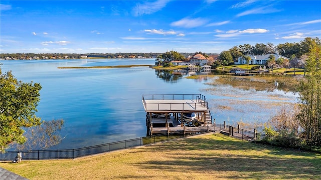 dock area with a water view and a lawn