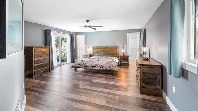 bedroom with dark hardwood / wood-style flooring, access to outside, and ceiling fan