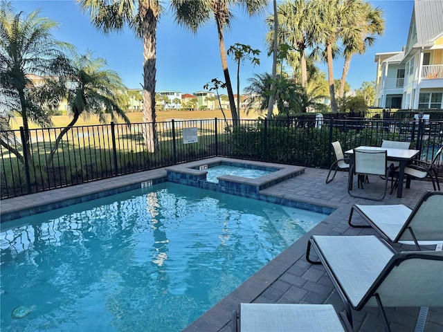 view of pool with an in ground hot tub and a patio area