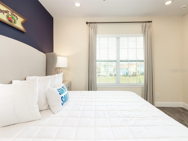 bedroom featuring multiple windows and hardwood / wood-style floors