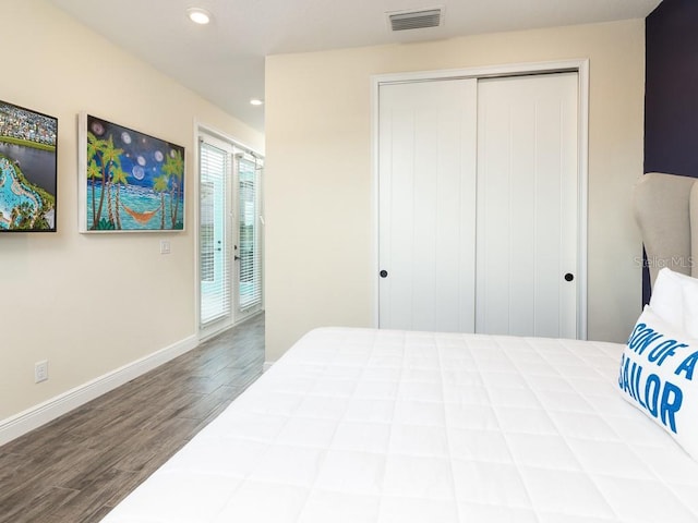 bedroom with access to outside, a closet, and hardwood / wood-style floors