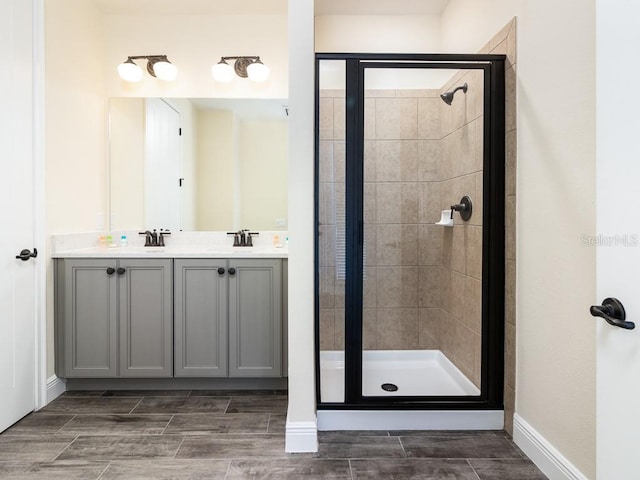 bathroom with vanity and a shower with shower door