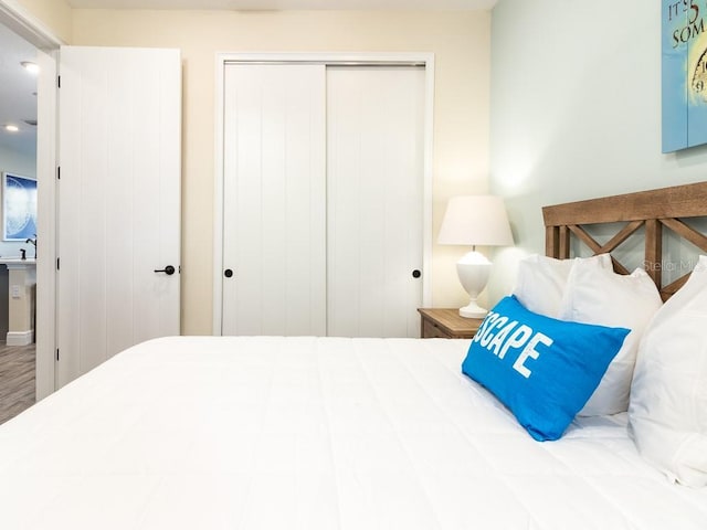 bedroom featuring hardwood / wood-style floors and a closet