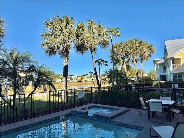 view of pool featuring an in ground hot tub and a patio