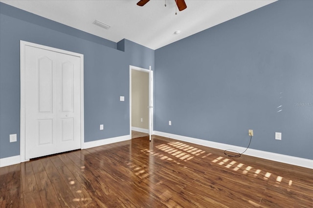 unfurnished bedroom with ceiling fan and dark hardwood / wood-style flooring