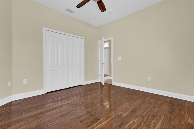 unfurnished bedroom featuring a closet, ceiling fan, and dark wood-type flooring