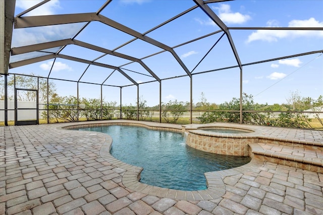 view of pool with a lanai, an in ground hot tub, and a patio