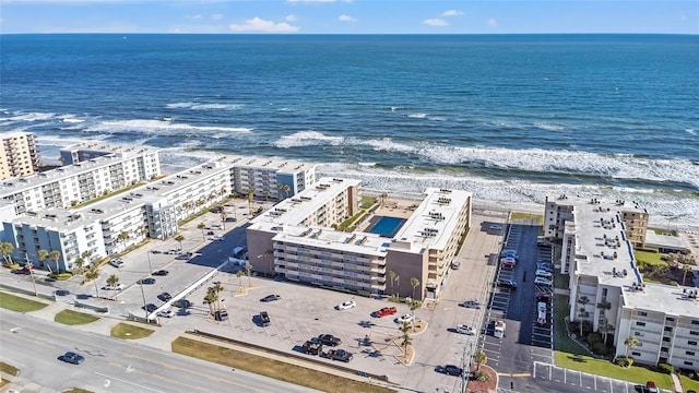 aerial view with a water view and a beach view