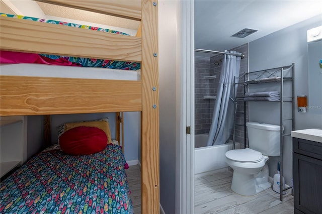 full bathroom featuring vanity, shower / bath combo, and toilet