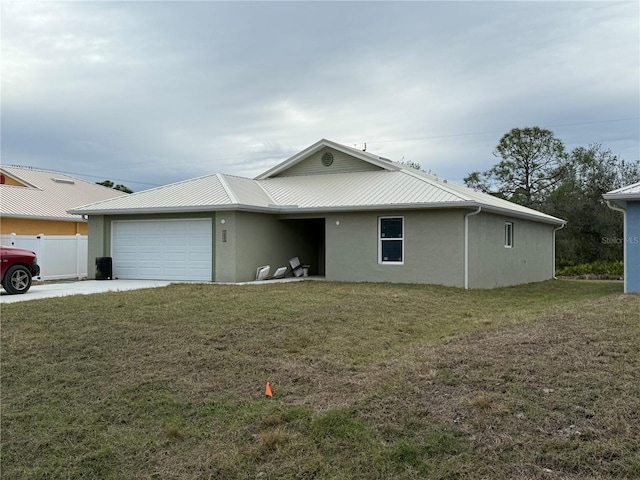 view of front facade with a garage and a front lawn