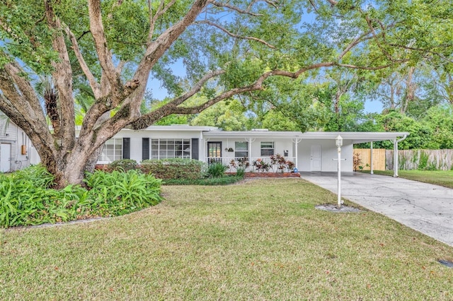 ranch-style house featuring a carport and a front yard