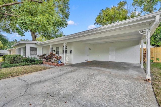 view of front of home with a porch and a carport