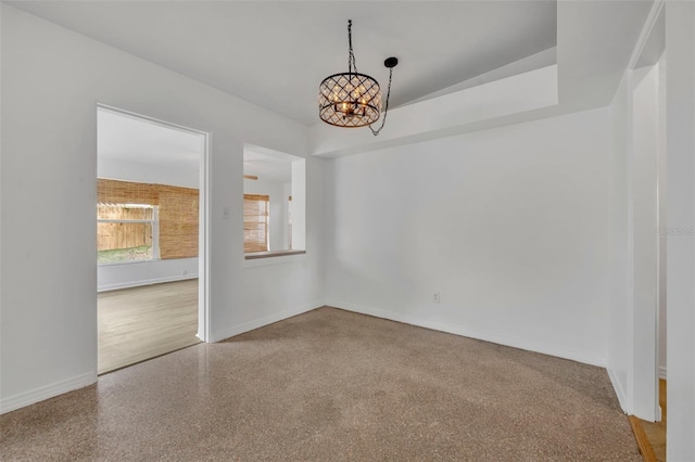 spare room with a chandelier