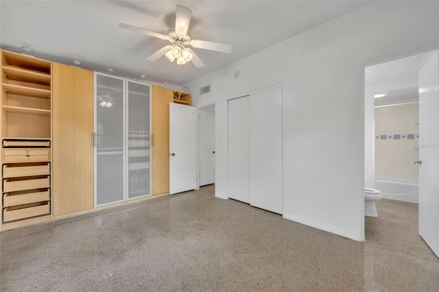 unfurnished bedroom featuring ceiling fan and ensuite bath