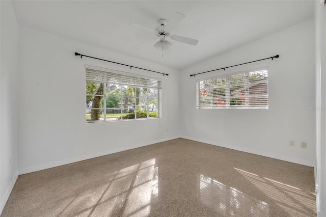 empty room featuring ceiling fan and lofted ceiling