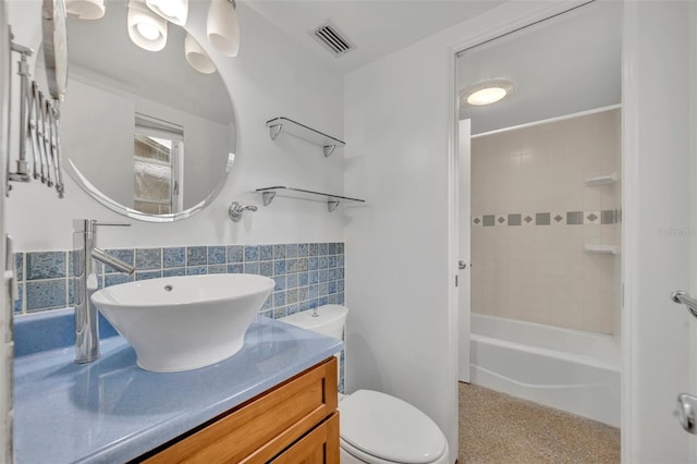 full bathroom featuring vanity, toilet, tile walls, and tiled shower / bath