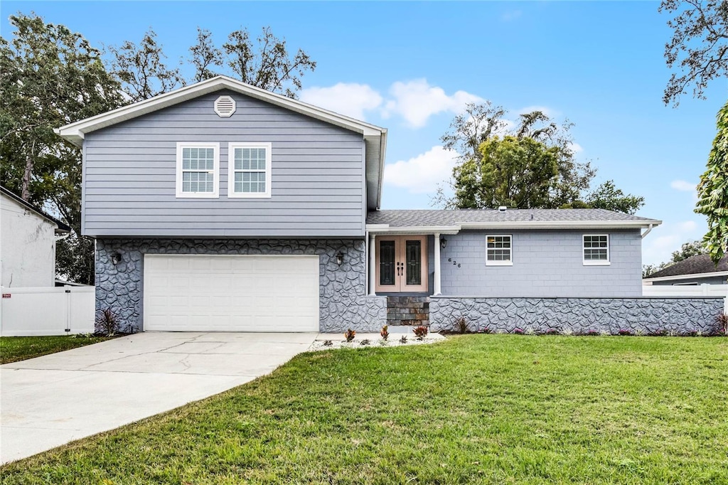 view of front of house featuring french doors, a garage, and a front yard