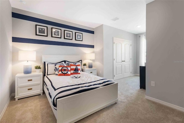 bedroom featuring light carpet and a closet