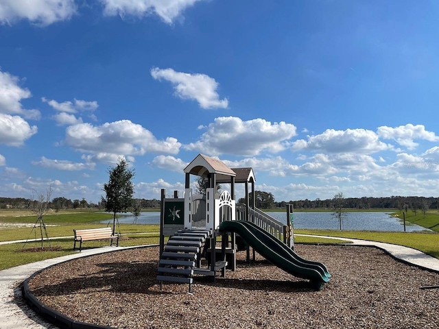 view of jungle gym with a yard and a water view