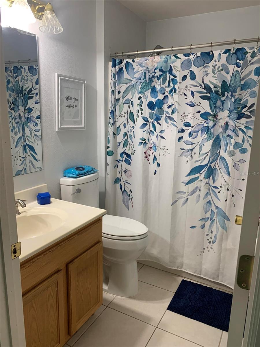 bathroom featuring tile patterned floors, vanity, and toilet