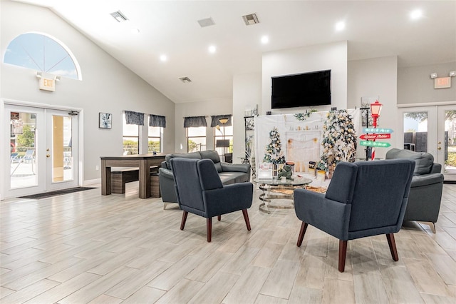 living room with a wealth of natural light, french doors, and high vaulted ceiling