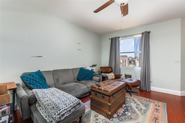 living room with ceiling fan and dark wood-type flooring