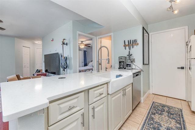 kitchen with ceiling fan, dishwasher, light tile patterned floors, kitchen peninsula, and white cabinets