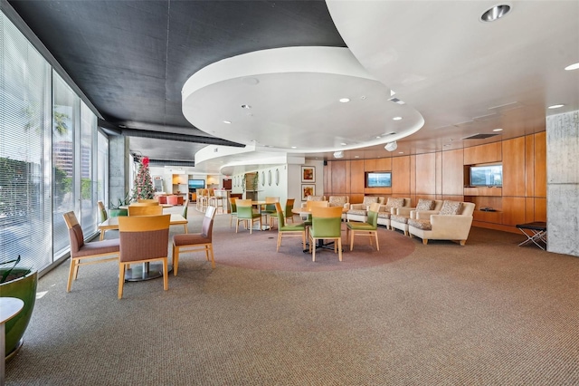 dining room featuring expansive windows and carpet