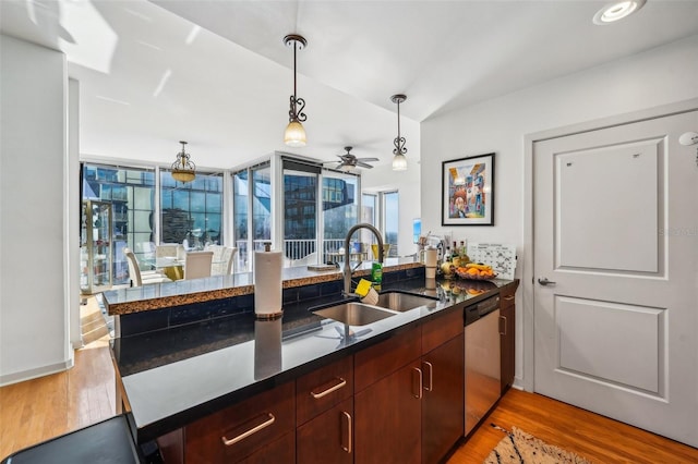 kitchen with ceiling fan, dishwasher, sink, kitchen peninsula, and light hardwood / wood-style floors