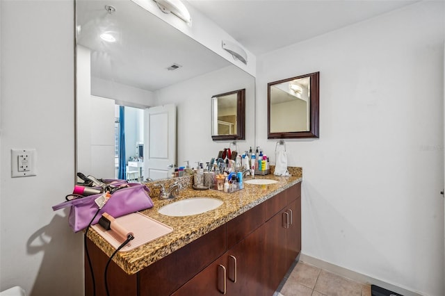 bathroom featuring tile patterned flooring and vanity