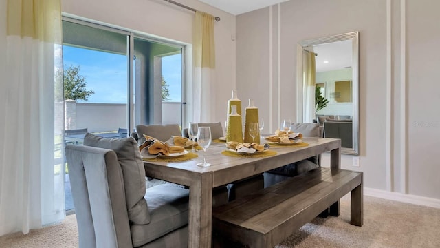 dining space featuring light colored carpet