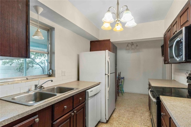 kitchen featuring sink, hanging light fixtures, stainless steel appliances, an inviting chandelier, and backsplash