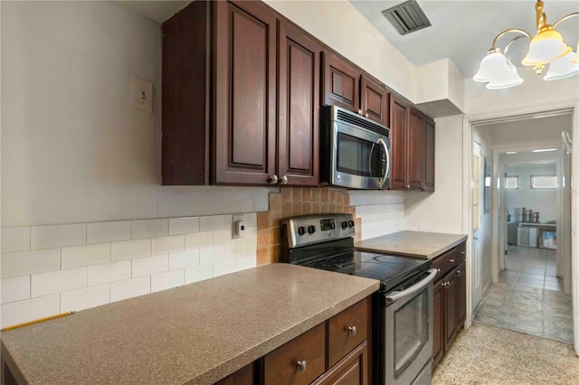 kitchen featuring hanging light fixtures, tasteful backsplash, dark brown cabinetry, stainless steel appliances, and a chandelier