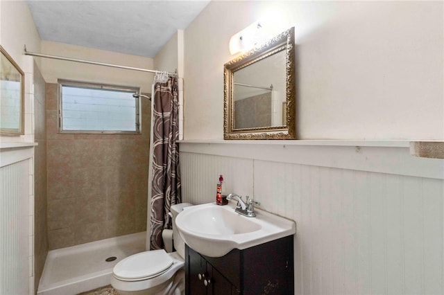 bathroom featuring a shower with curtain, vanity, toilet, and wooden walls