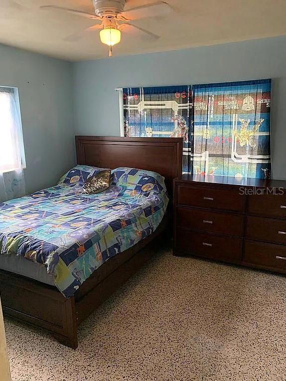 2695 S E Ave, Sarasota, FL 34239 - bedroom with dark speckled floor and ceiling fan
