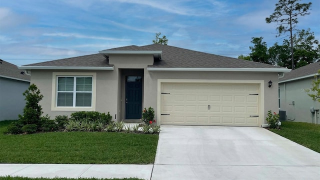 ranch-style house with a garage, a front lawn, and central air condition unit