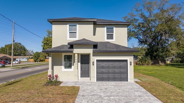 view of front of home featuring a front lawn and a garage