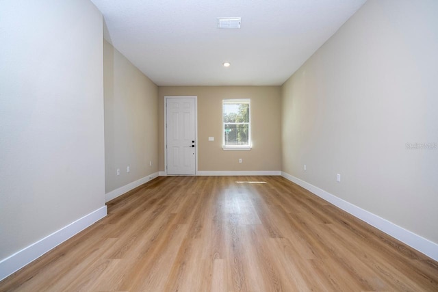 spare room featuring light hardwood / wood-style flooring