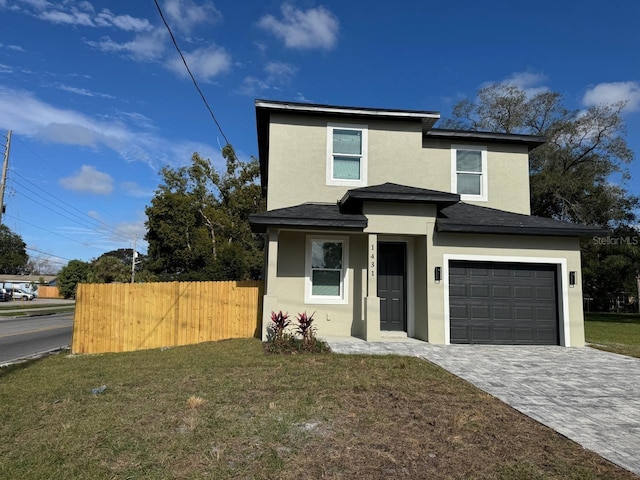 view of front of property featuring a front lawn and a garage