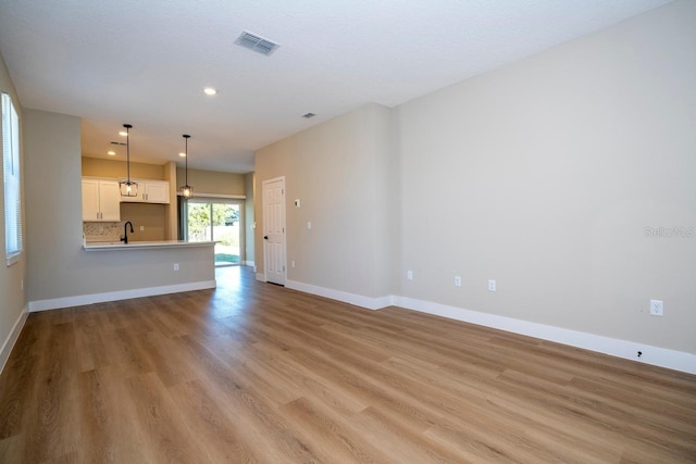 unfurnished living room featuring light hardwood / wood-style flooring