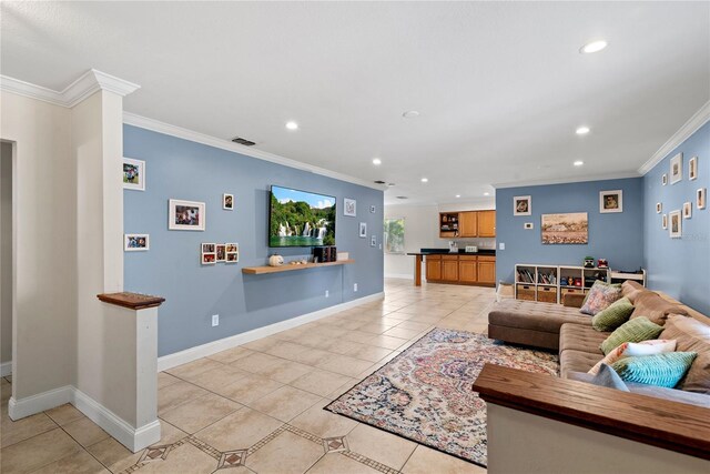 tiled living room featuring crown molding