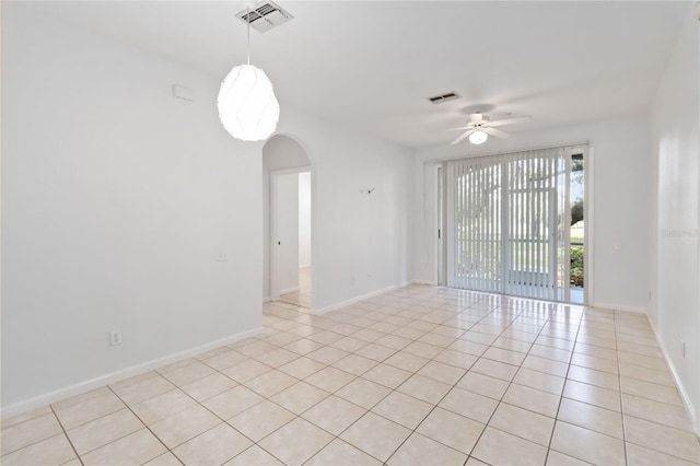 spare room featuring ceiling fan and light tile patterned floors