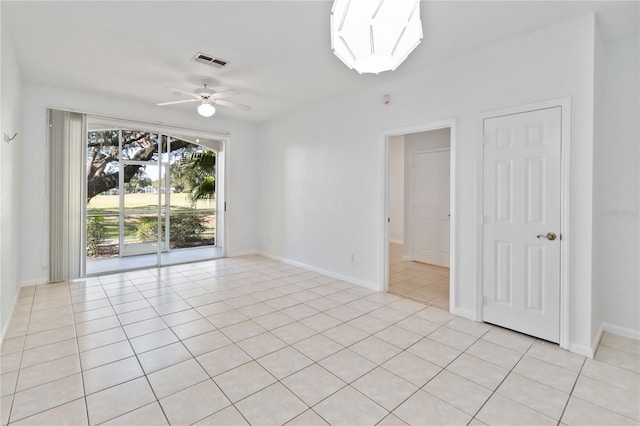 tiled empty room featuring ceiling fan