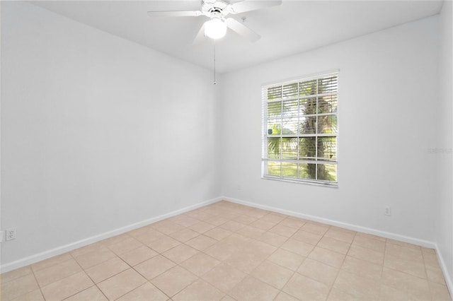 tiled empty room featuring ceiling fan